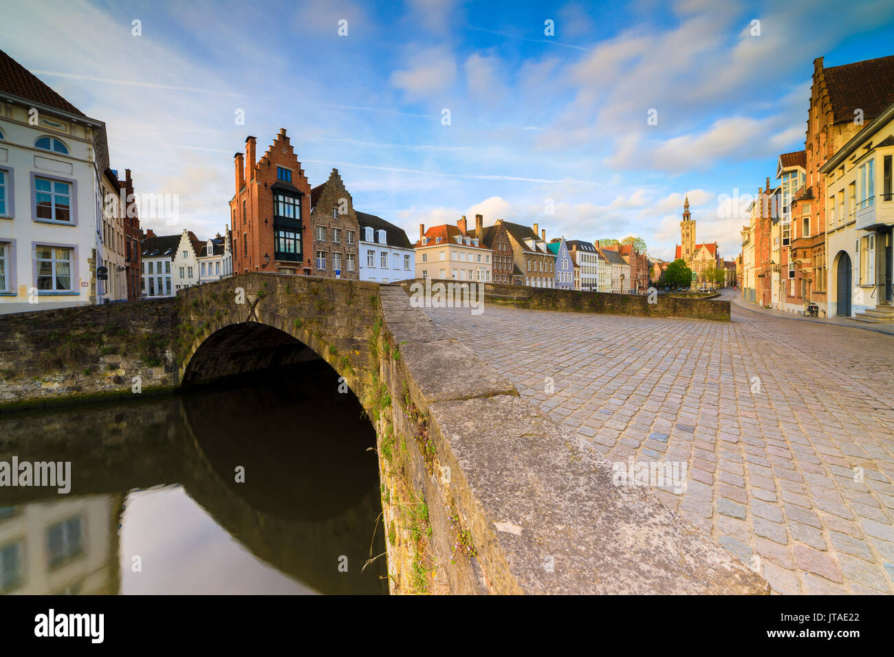 Pink clouds at dawn on the typical buildings and quay along the typical canal, Bruges, West Flanders, Belgium, Europe Stock Photo
