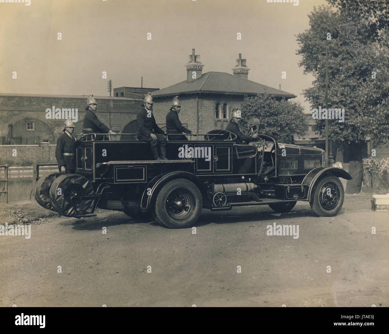 Firemen with fire engine, Fire brigade, c1930s, historic archive photograph Stock Photo