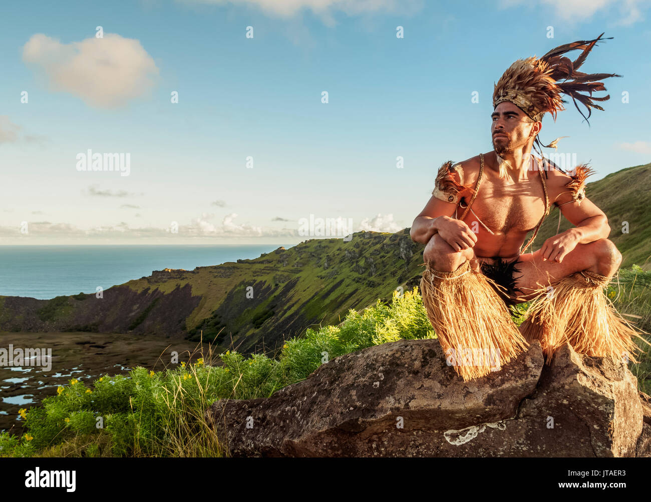 Native Rapa Nui man in tradititional costume on the rim of the Rano Kau Volcano, UNESCO, Easter Island, Chile Stock Photo