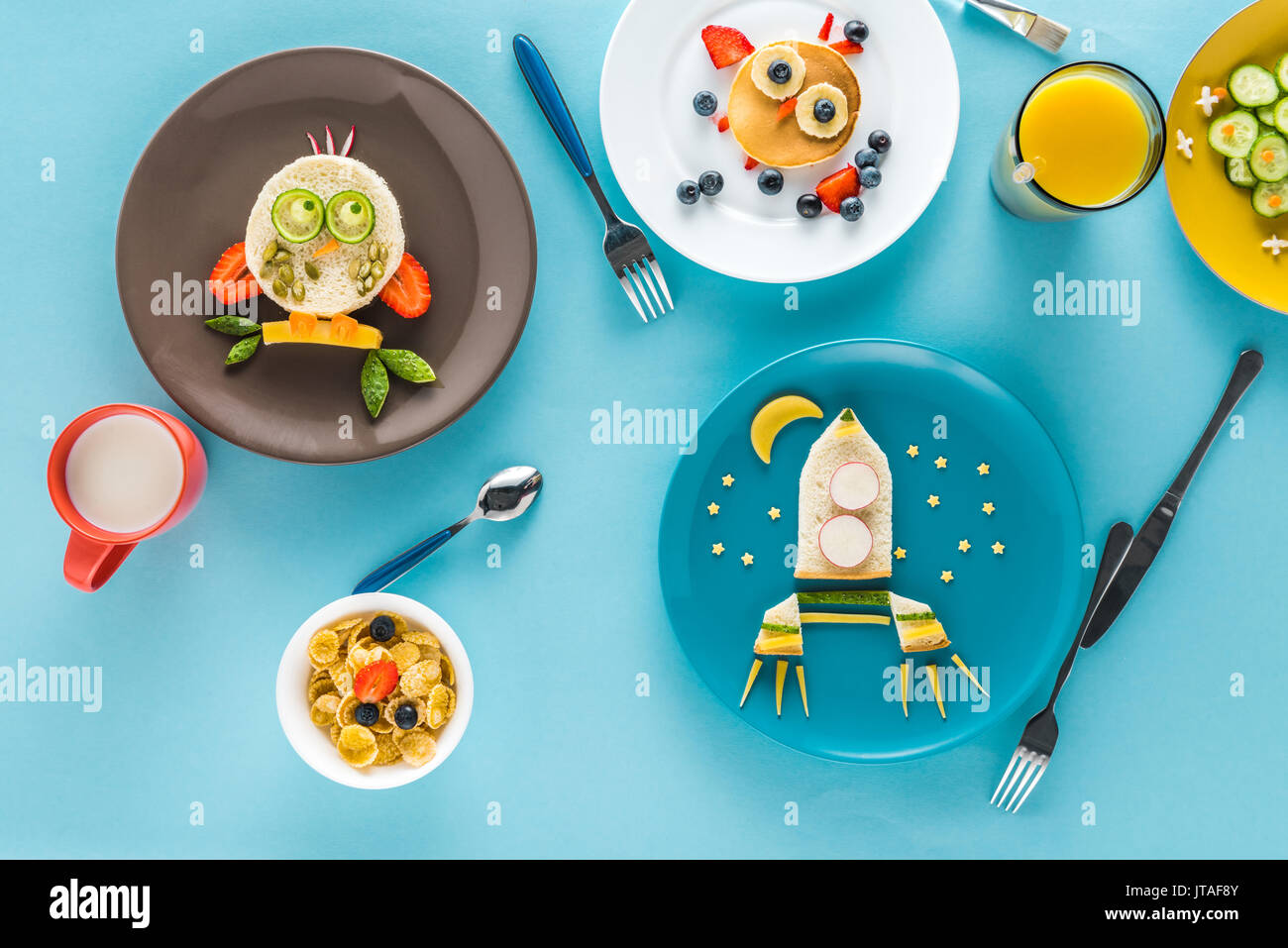 flat lay with creatively styled children's breakfast with drinks on plates Stock Photo