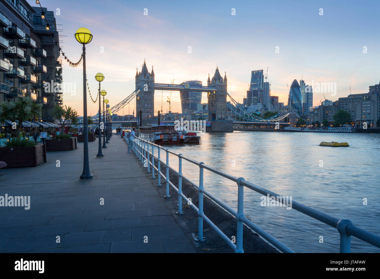 Tower Bridge and City of London skyline from Butler's Wharf at sunset, London, England, United Kingdom, Europe Stock Photo