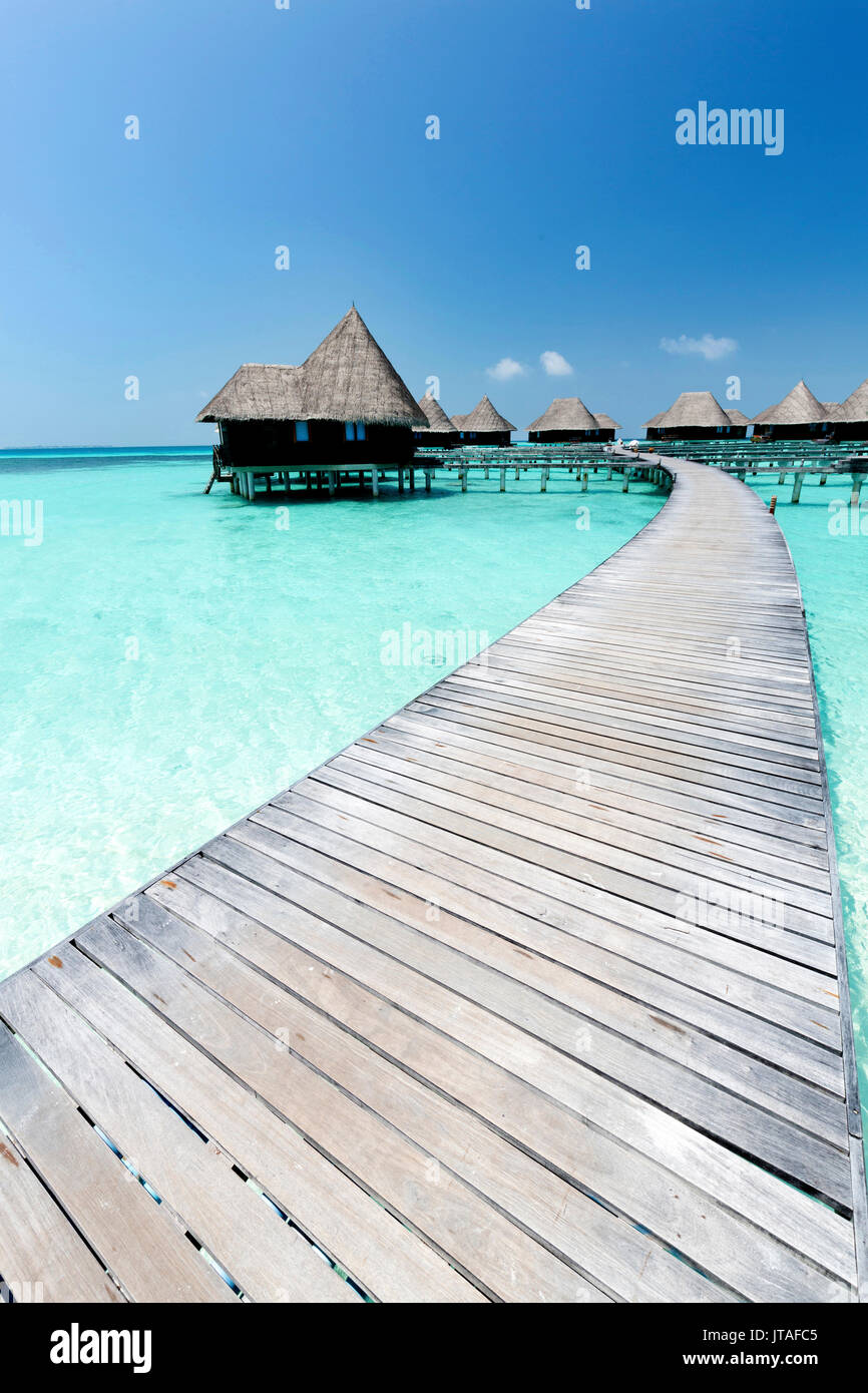 Over-water villas, crystal clear sea and blue sky, Coco Palm, Dhuni Kolhu, Baa Atoll, Republic of Maldives, Indian Ocean, Asia Stock Photo