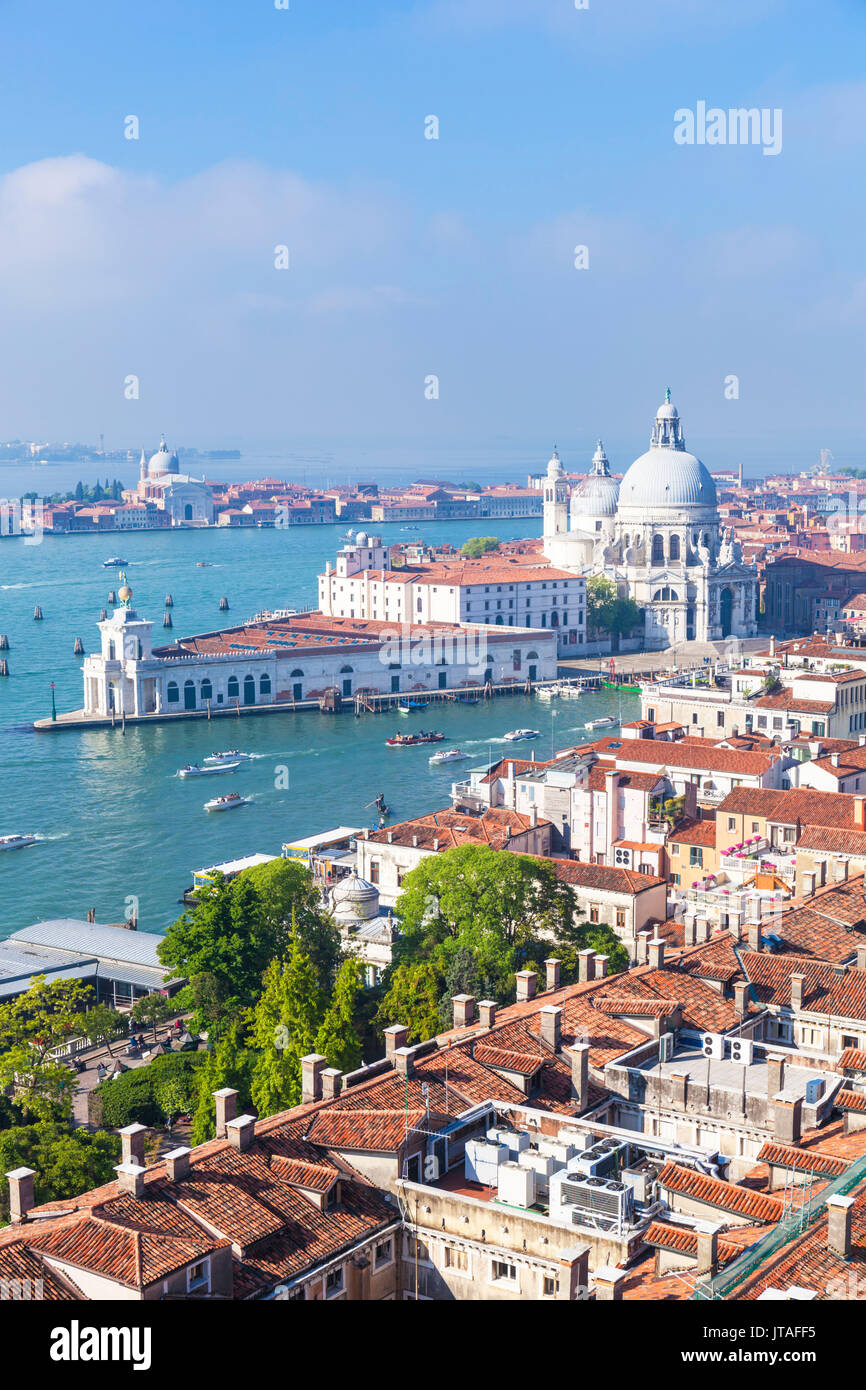 Vaporettos (water taxis), rooftops and the church of Santa Maria della Salute, on the Grand Canal, UNESCO, Venice, Veneto, Italy Stock Photo