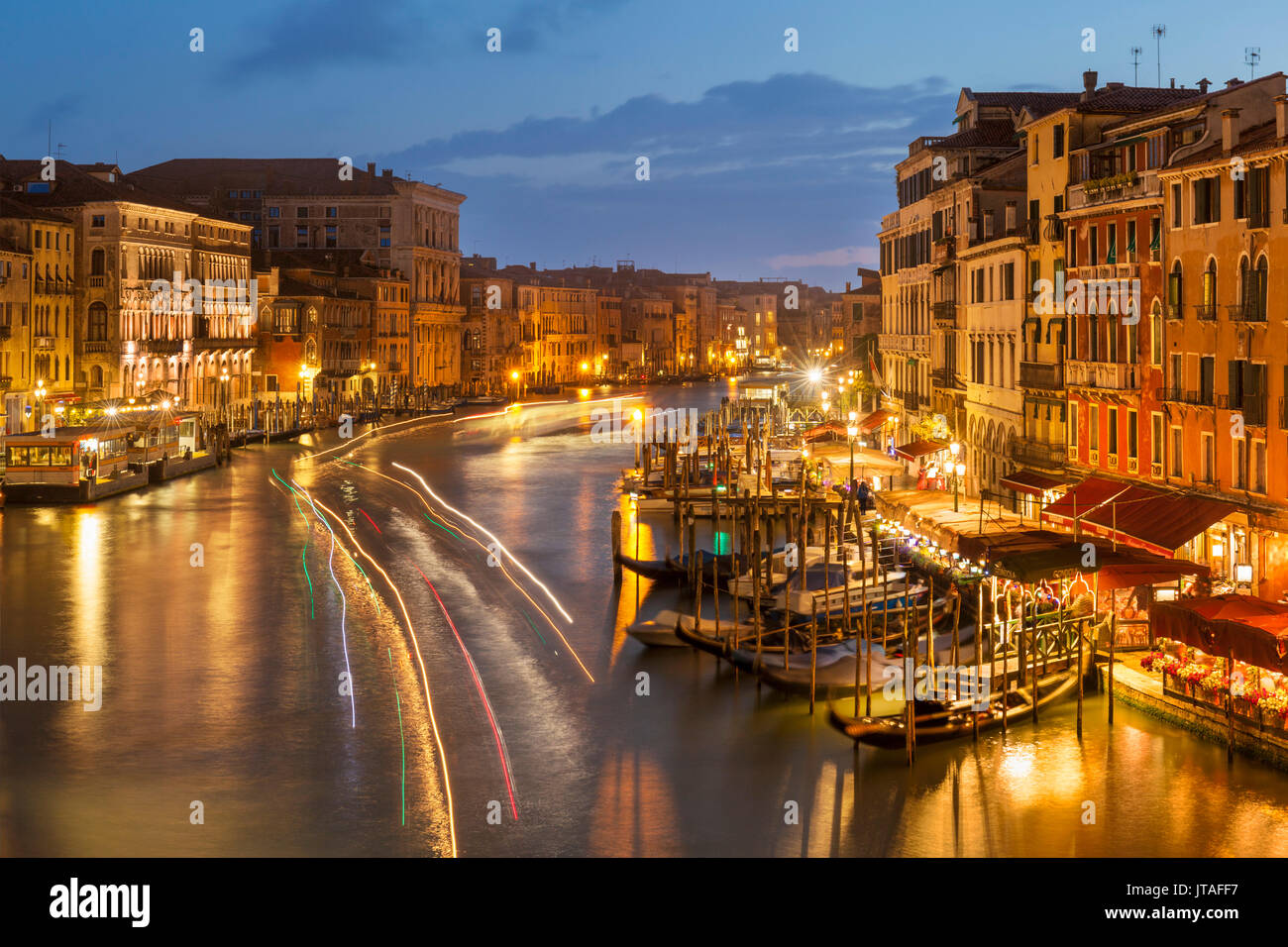 Grand Canal at night with boat light trails and moored gondolas, on the Fondementa del Vin, UNESCO, Venice, Veneto, Italy Stock Photo