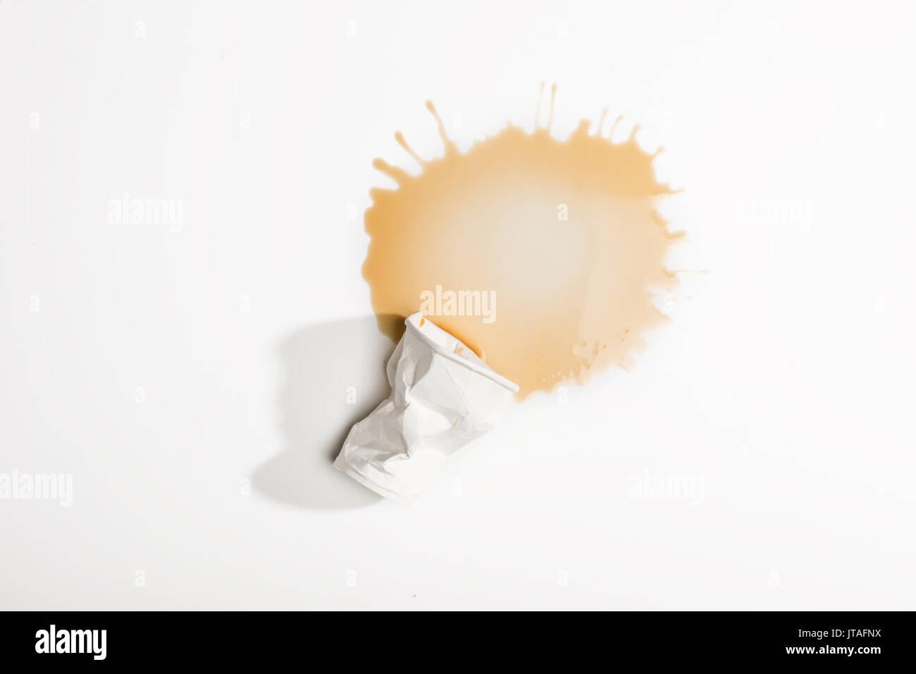 top view of crumpled used paper cup with spilled coffee isolated on ...