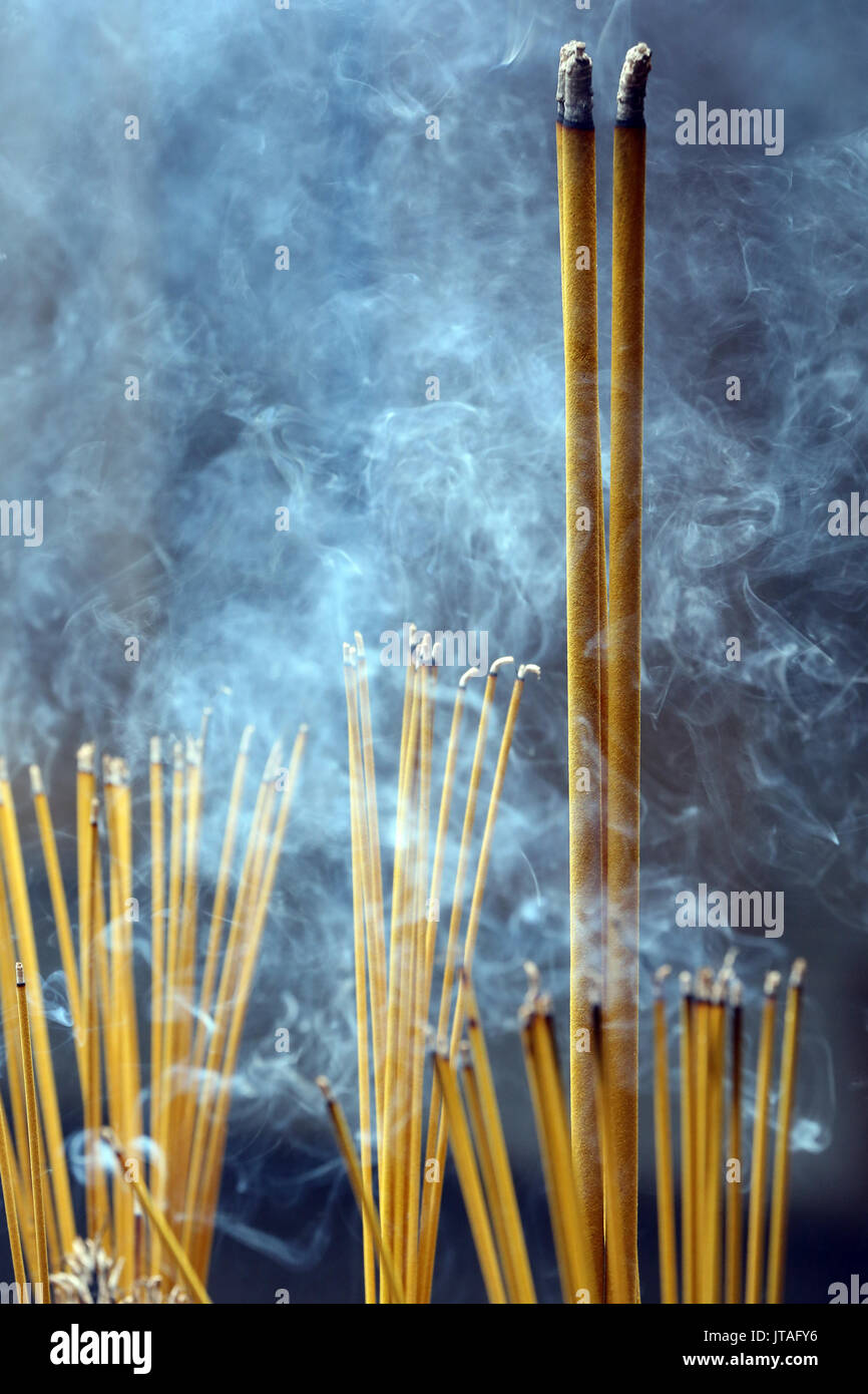 Incense sticks on joss stick pot burning and smoke, Taoist temple