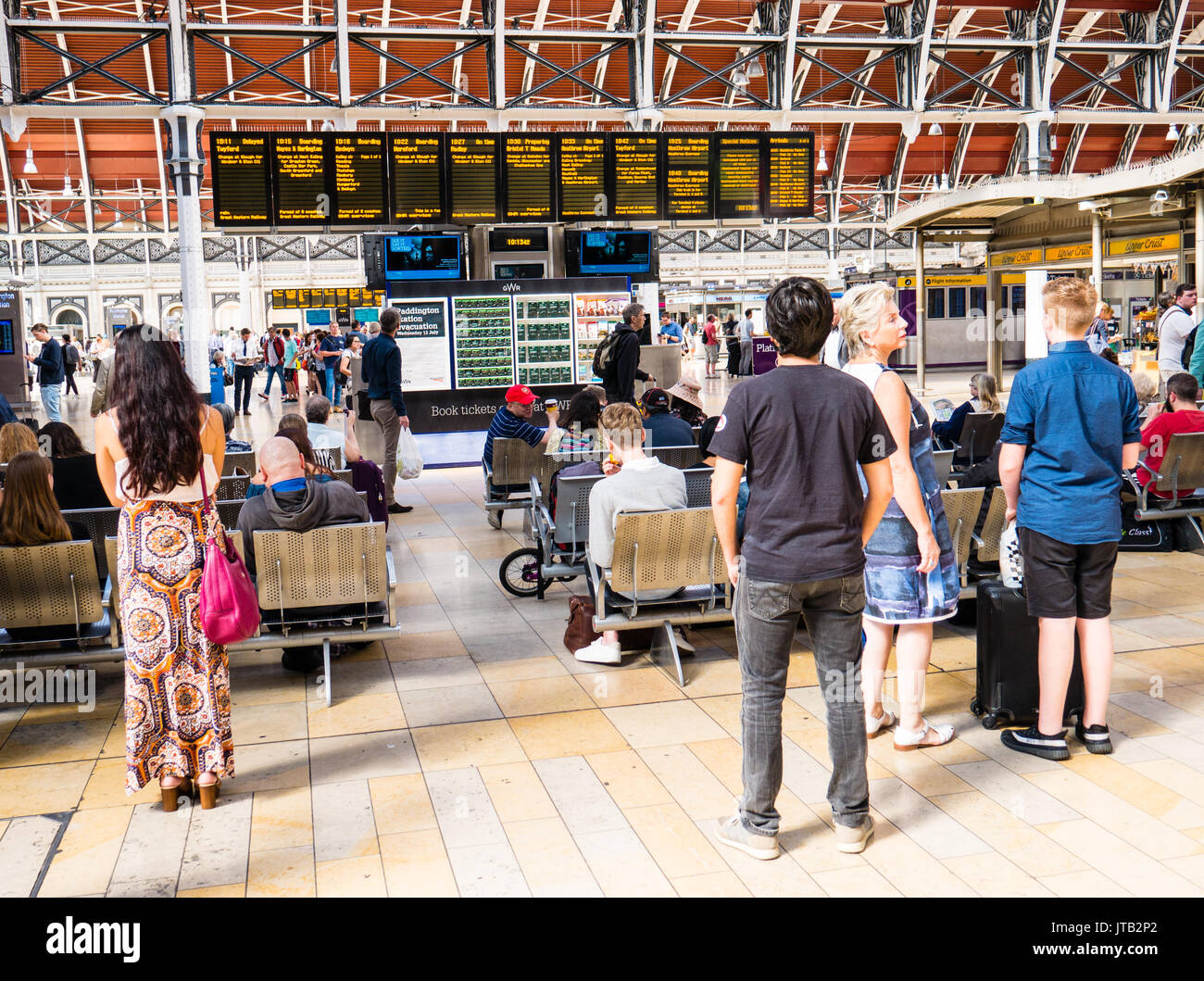 Rail Travelers, looking at Departure Boards, London Paddington Rail Station, City of Westminster