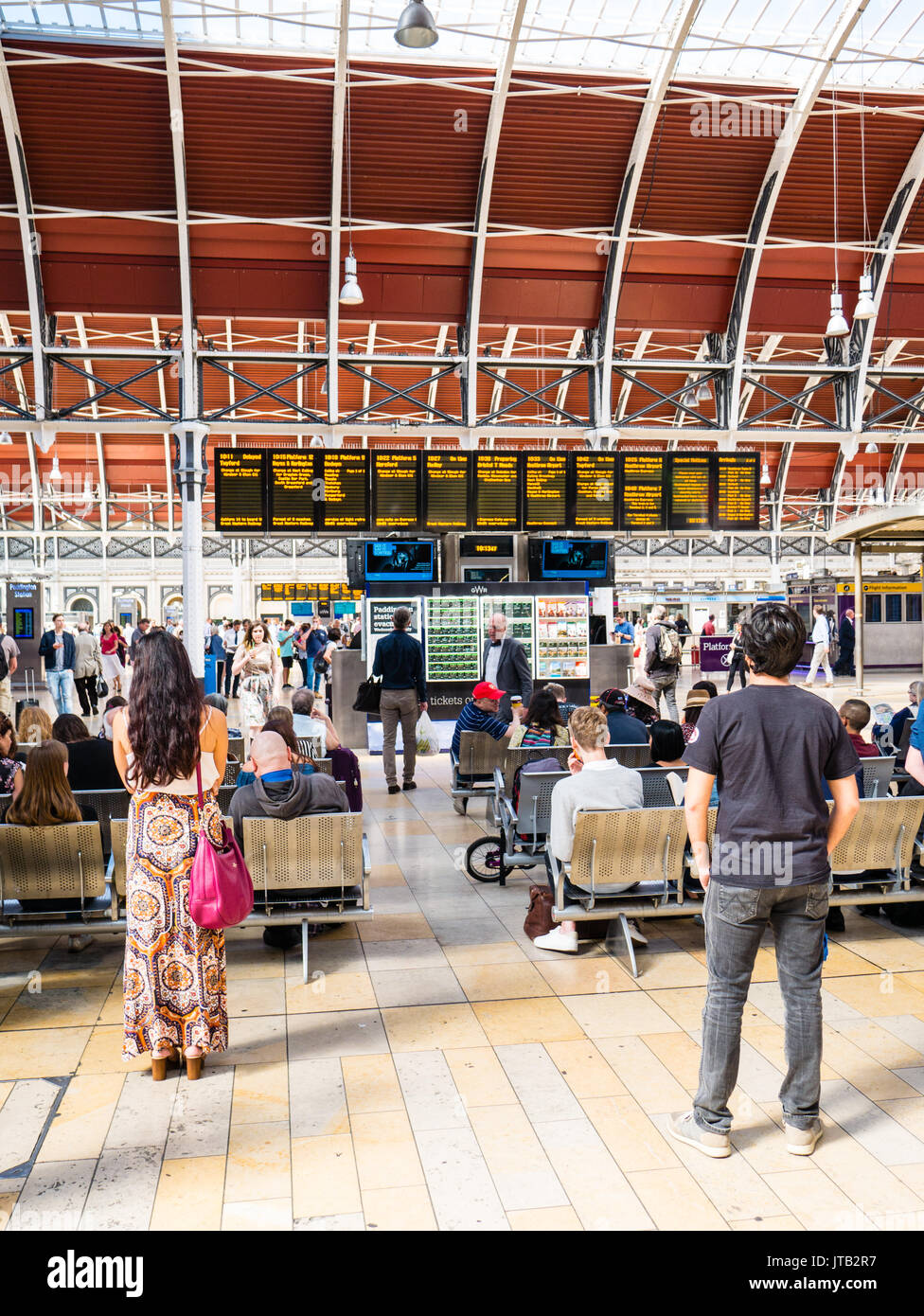 Rail Travelers, looking at Departure Boards, London Paddington Rail Station, City of Westminster