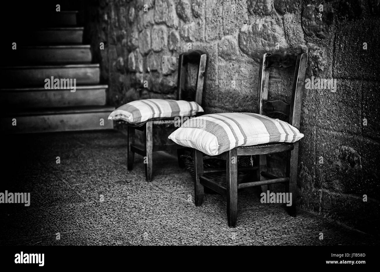 Old wooden village chairs, detail of old furniture in an old basement Stock Photo