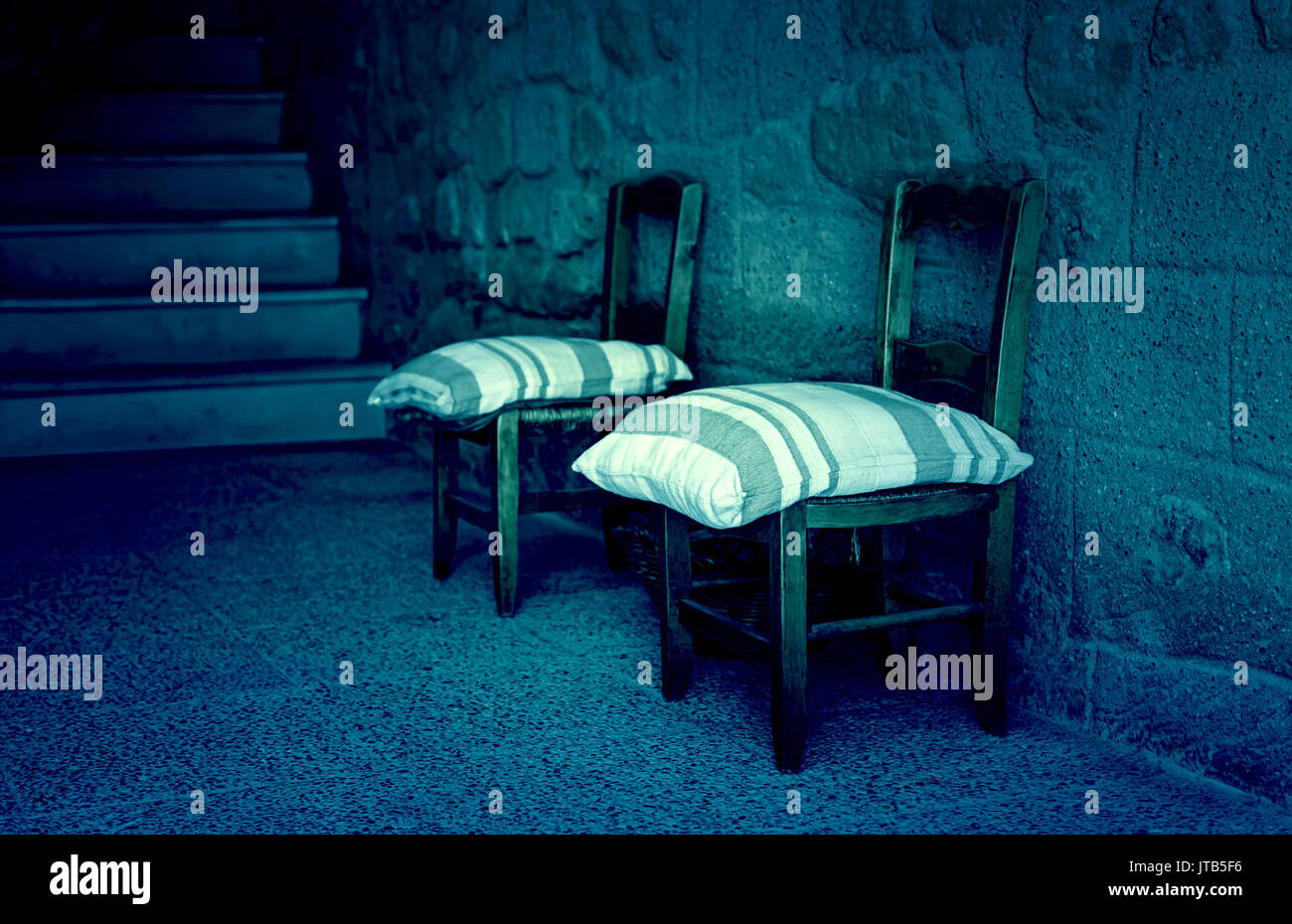 Old wooden village chairs, detail of old furniture in an old basement