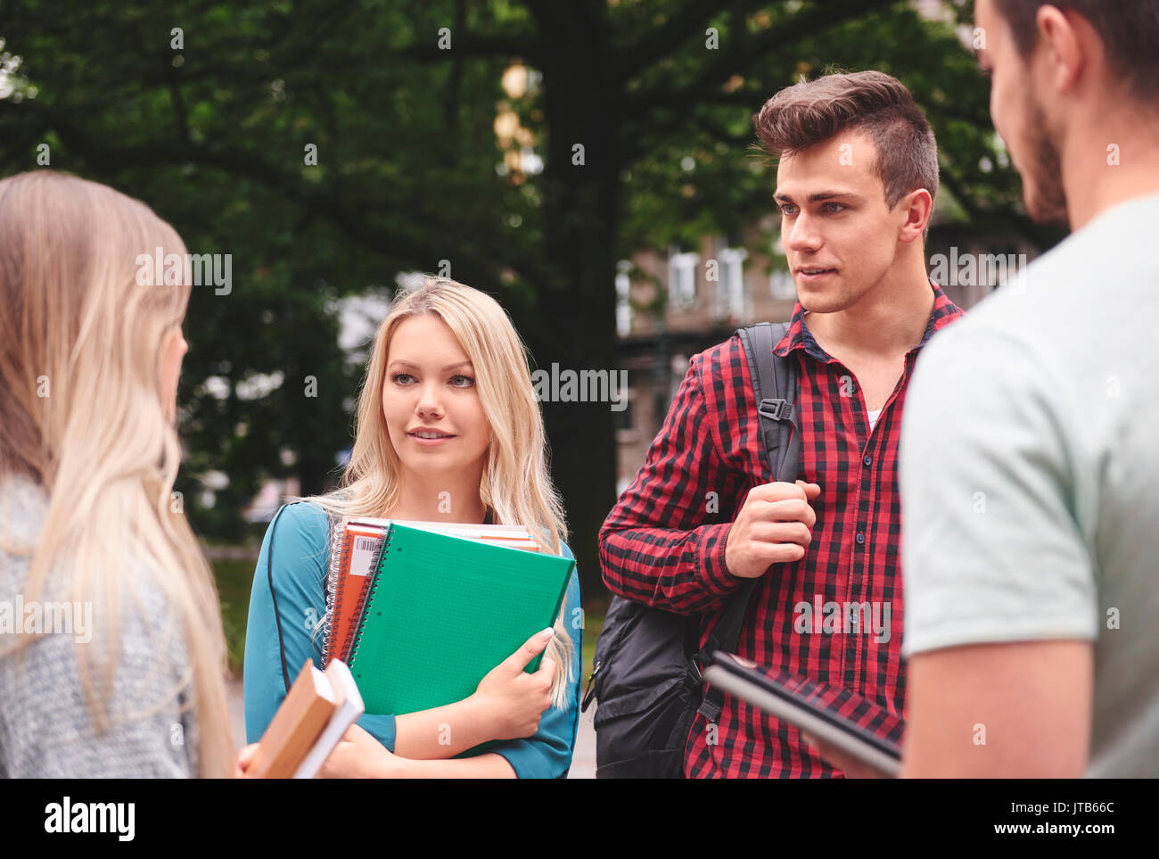 Young people talking and socializing outside Stock Photo