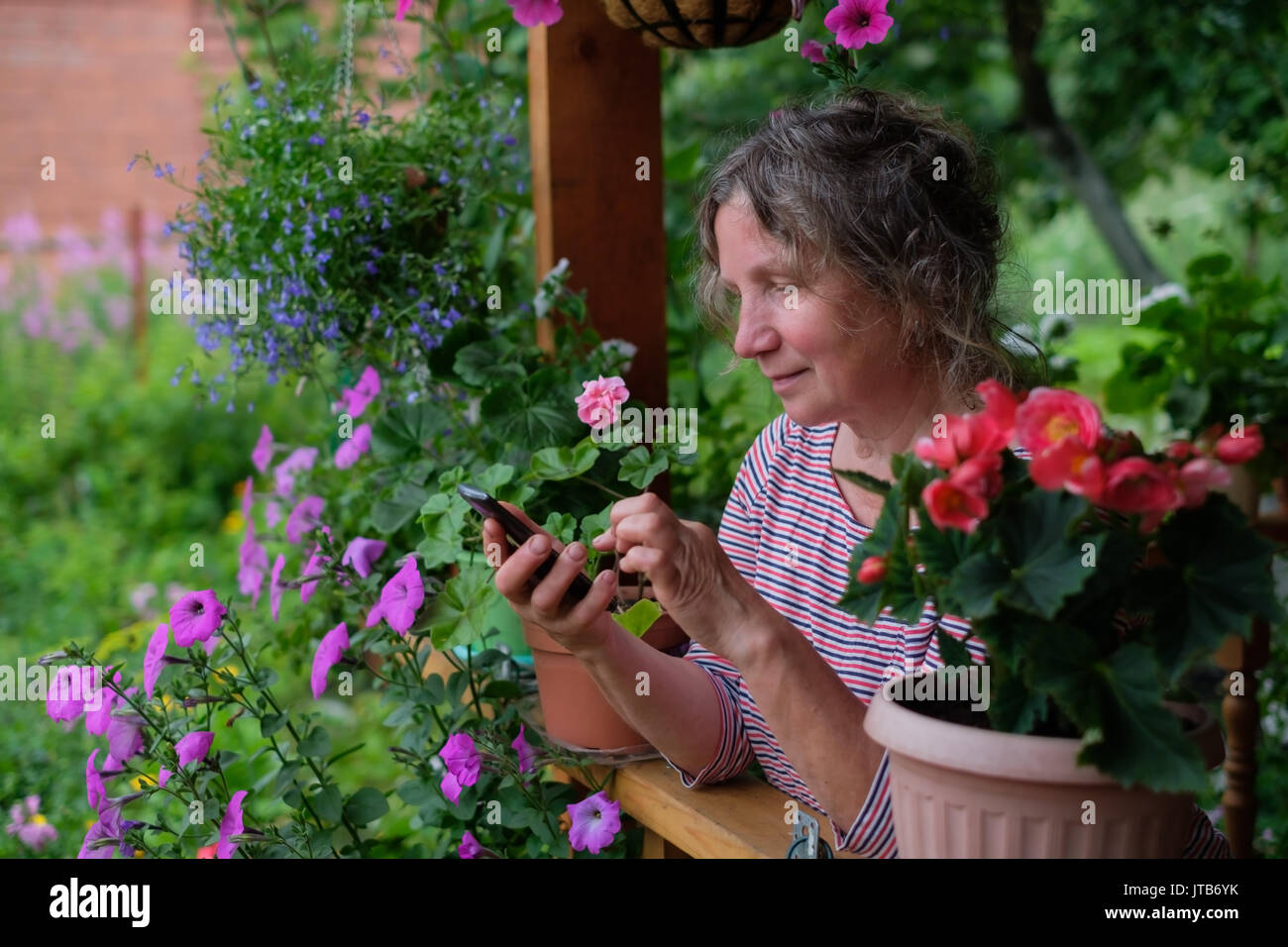 Happy mature woman calling hi-res stock photography and images - Alamy