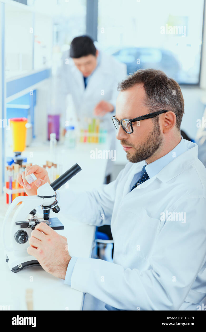 young doctors in uniform working at testing laboratory, laboratory