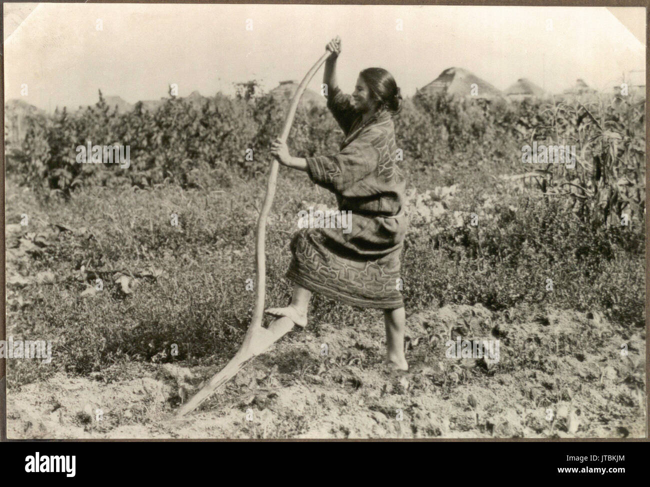 Woman with a digging stick Stock Photo