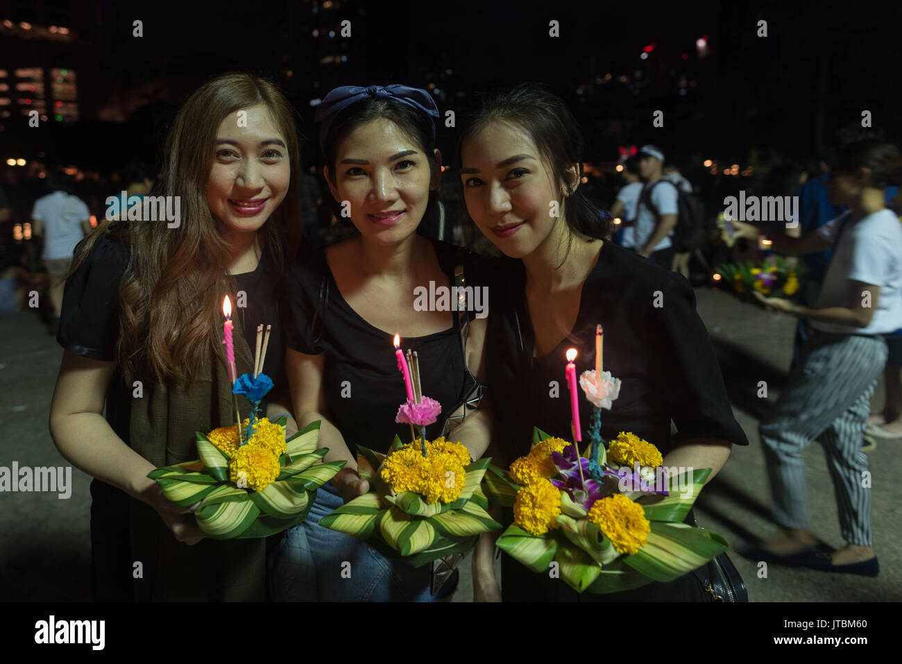 Three Thai girls pose with their Krathong on Loy Krathong festivity in 2016 Stock Photo