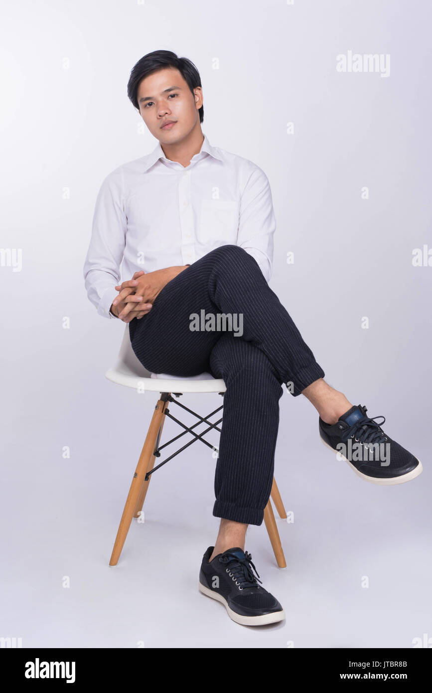 Trendy young man sitting chair hi-res stock photography and images - Alamy