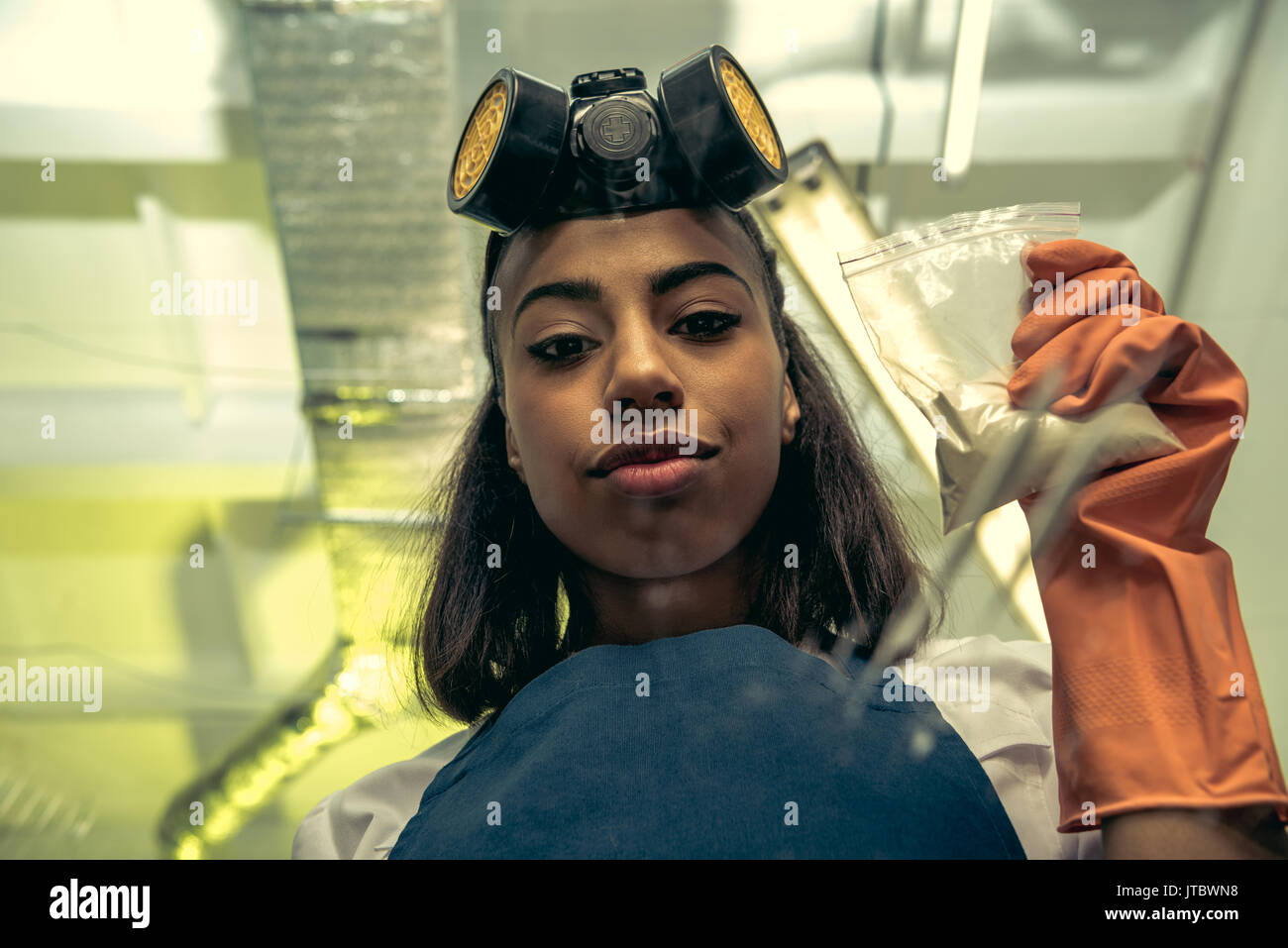 young girl laboratory technician in personal protective equipment
