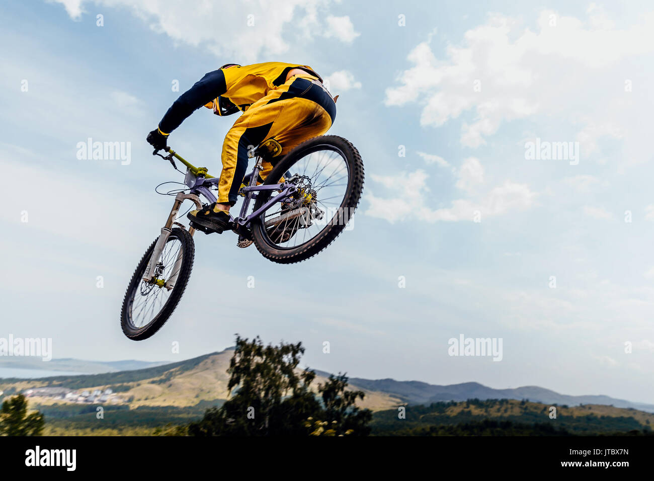 cyclist rider jump downhill mountain biking Stock Photo