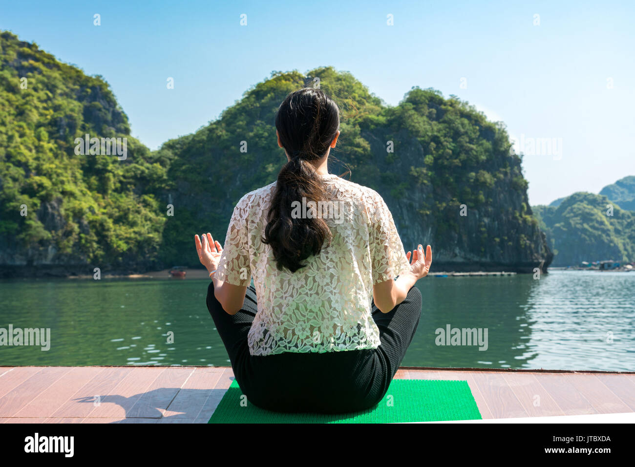 Girl meditating on a cruise boat deck Stock Photo