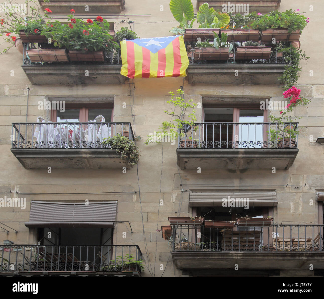catalan flag over old town balconies in barcelona  the barri gotic district  spain Stock Photo