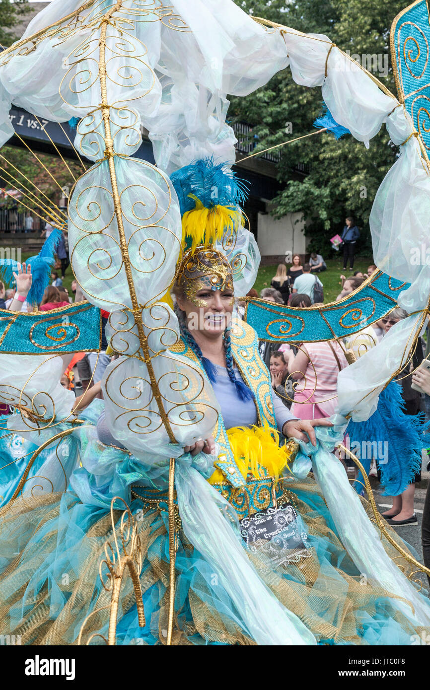 A white woman in a colourful blue and white costume at the Stockton