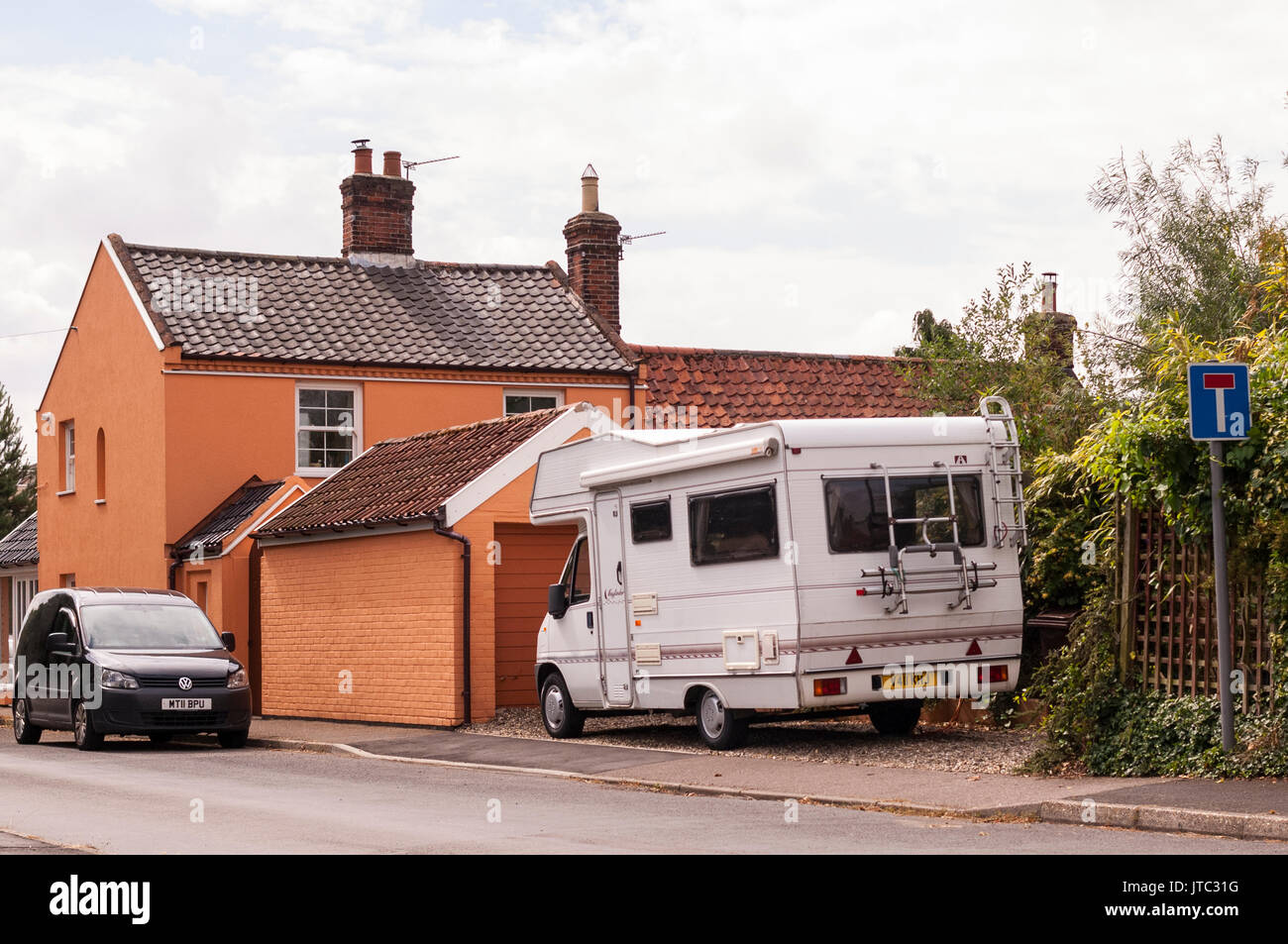 A caravanette campervan parked outside a house in the Uk Stock Photo