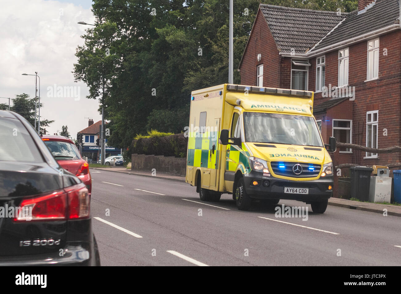 An ambulance on emergency call with blue lights flashing in  Norwich , Norfolk , England , Britain ,  Uk Stock Photo