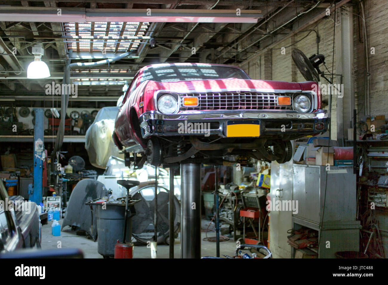 A classic vintage American car on the lift waiting to be repaired Stock Photo