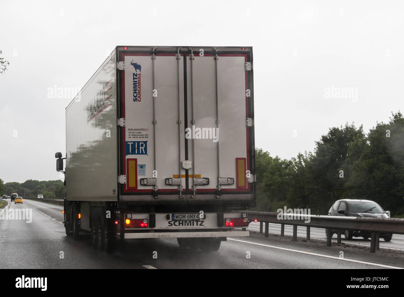 A foreign HGV lorry driving on a main road in the Uk Stock Photo