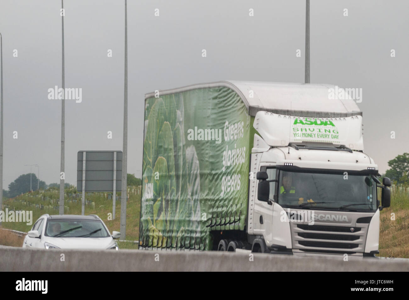 A Scania Asda deivery HGV Lorry driving on a main road in the Uk Stock Photo