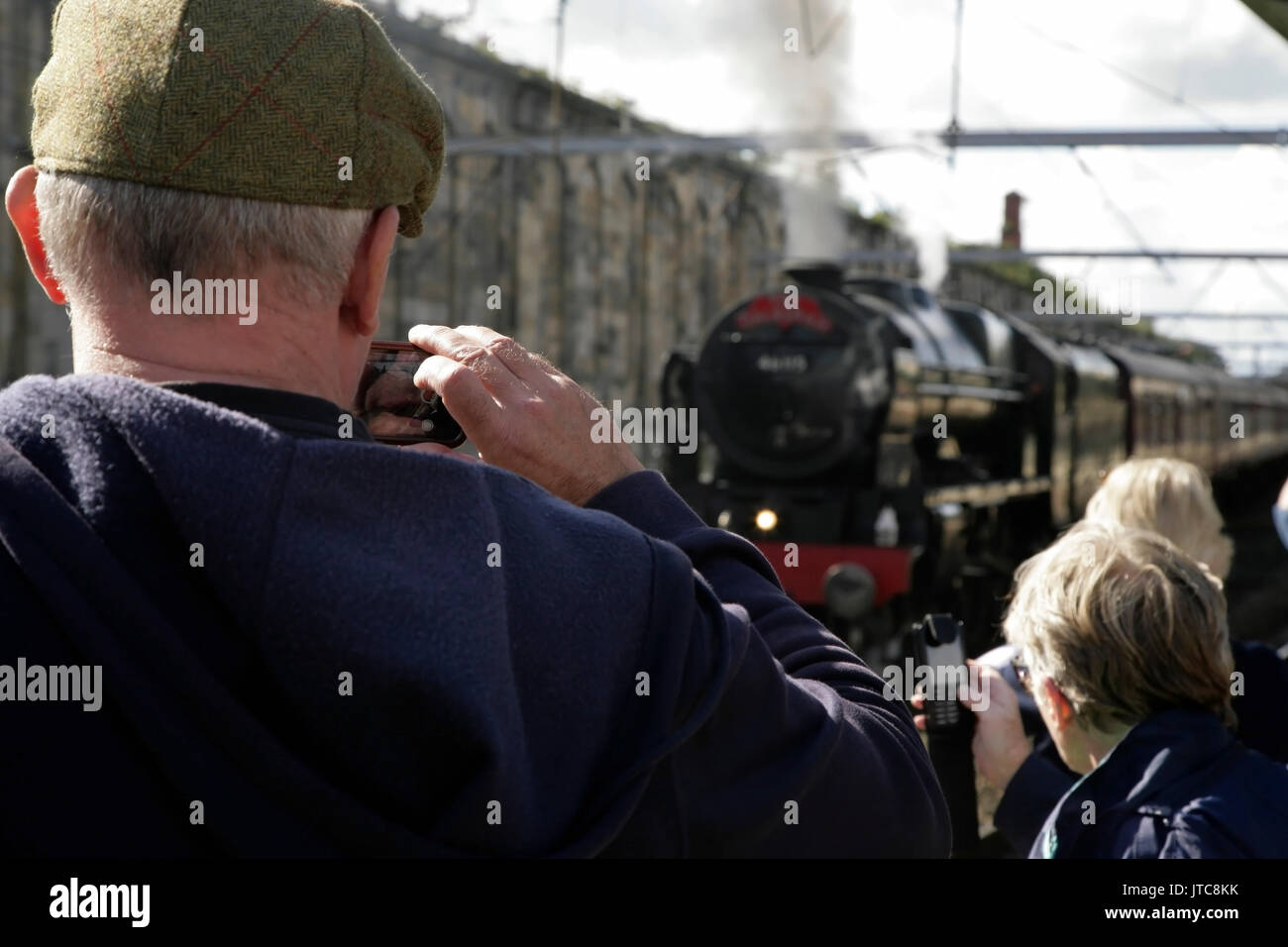 People photographing LMS Royal Scot class 7P steam engine 'Scots Guardsman' with 'The Dalesman' train at Carlisle station, UK. Stock Photo