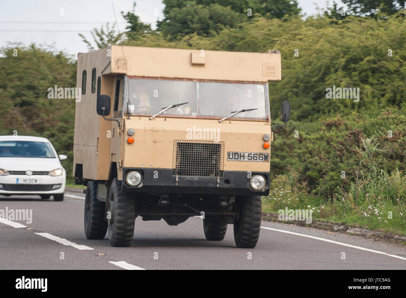 A classic MOD vehicle driving on a main road in the Uk Stock Photo