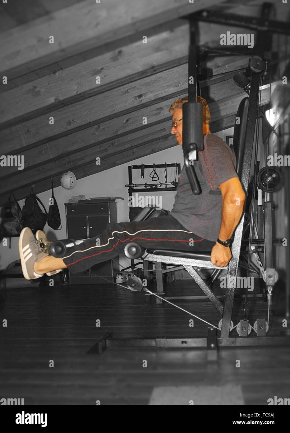 Home gym in the attic, Leg Extension Stock Photo Alamy
