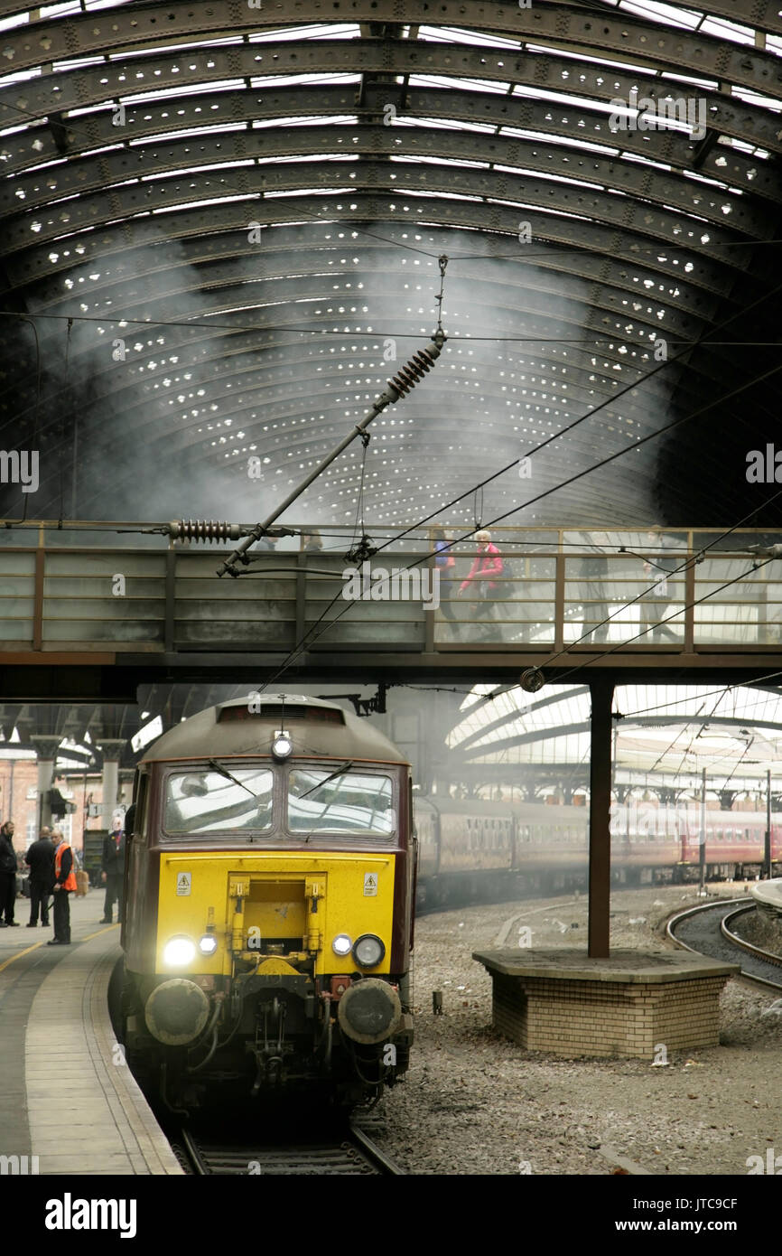Class 57 diesel making a smoky start at York station, UK