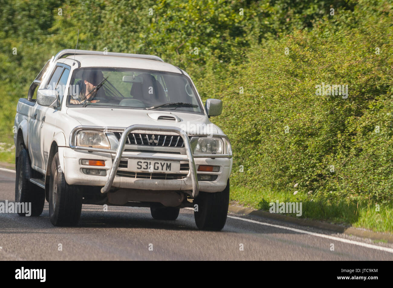 A Mitsubishi L200 driving on a main road in the Uk Stock Photo