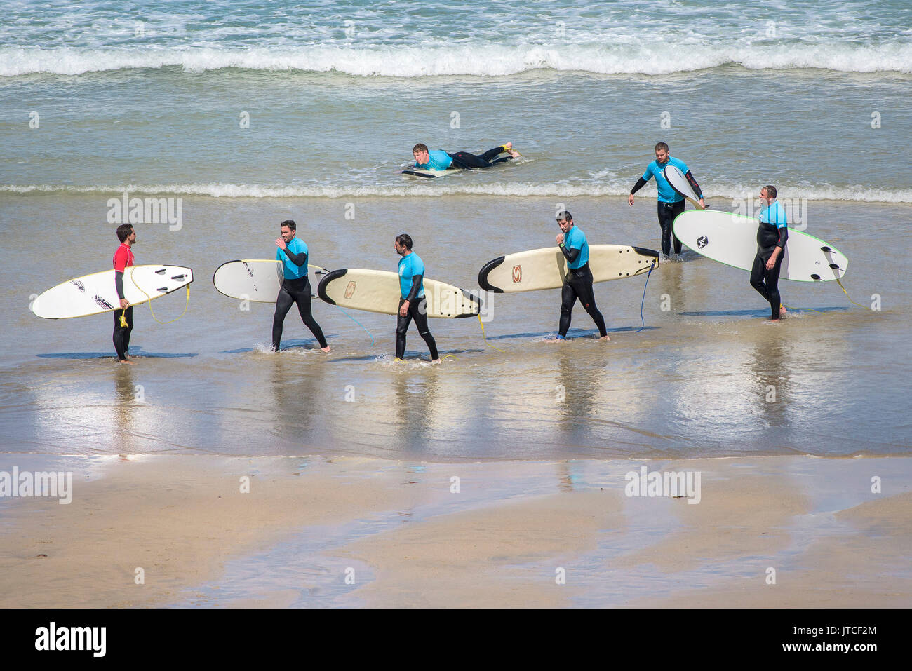 A surf instructor and his students on a beach in Newquay, Cornwall Stock Photo Alamy
