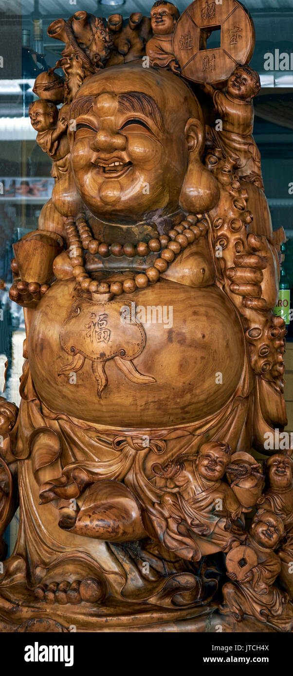 Chinese Buddha.. Ornately carved wooden figure Stock Photo