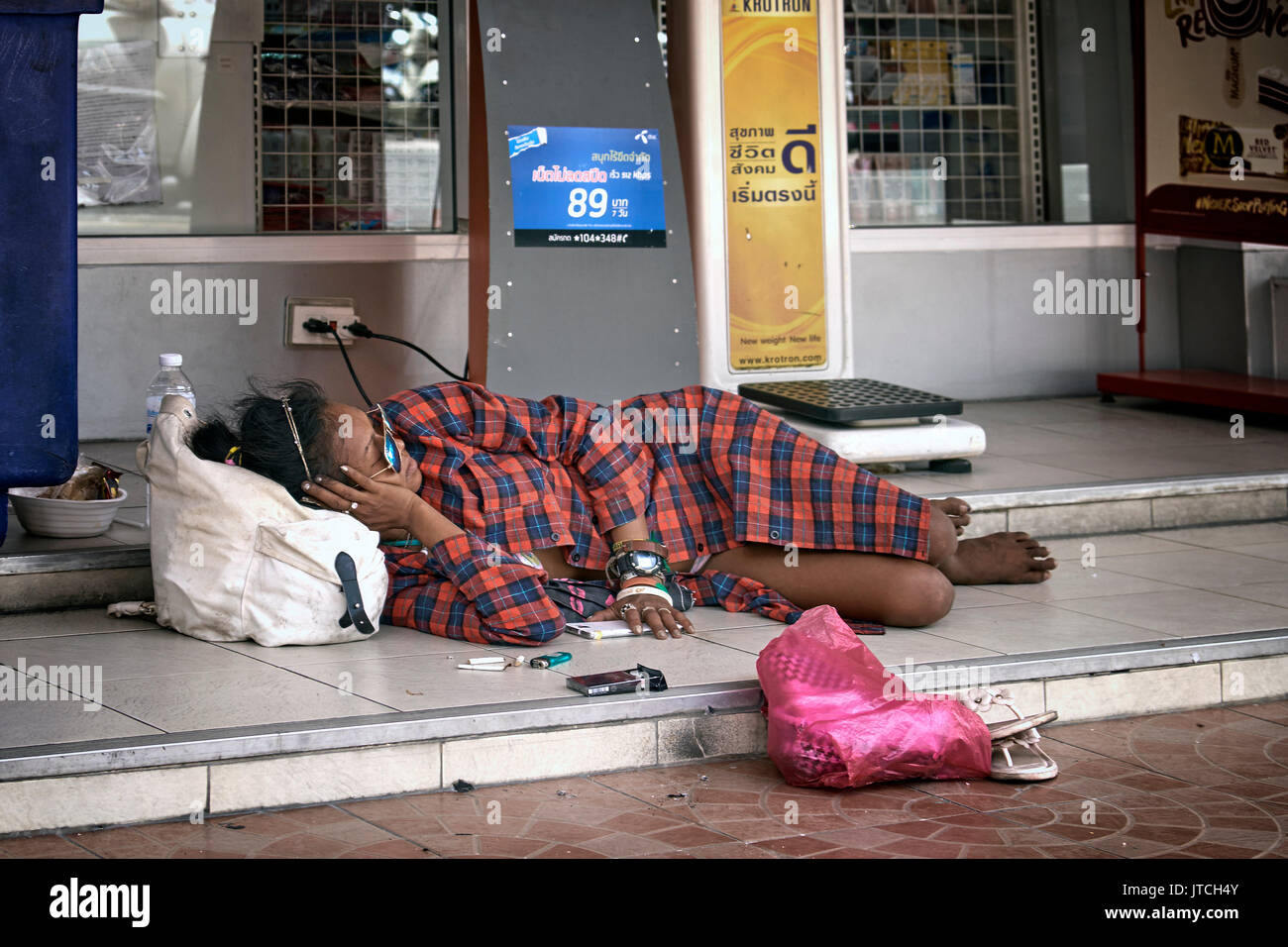 Homeless woman asleep on the street. Thailand Southeast Asia Stock Photo