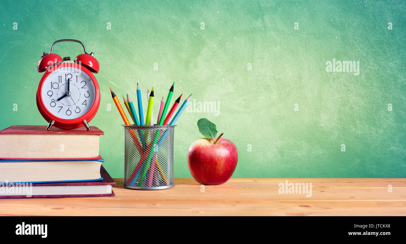 Alarm Clock And Stack Of Books With Pencils And Apple Back To School