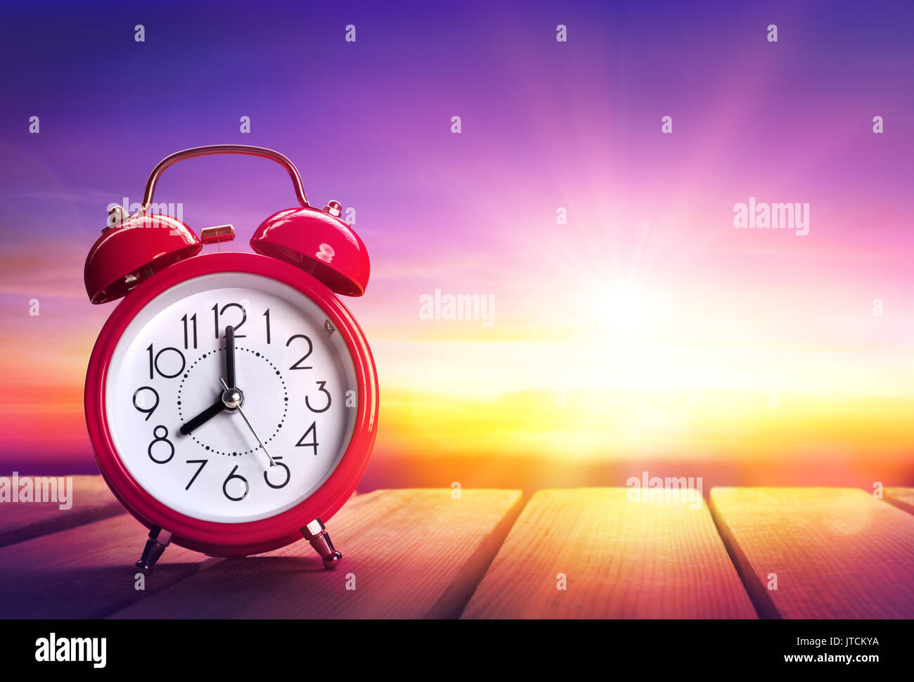 Clock Alarm At Sunrise - Waking Up Concept Stock Photo