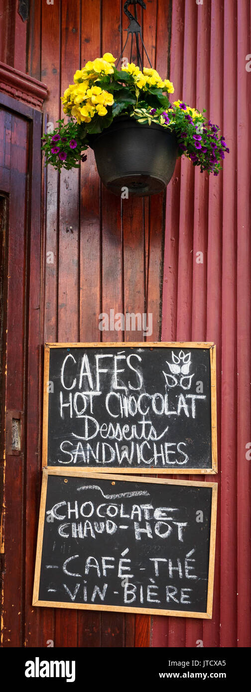 Handwritten menu items on a chalkboard sign outside an eatery in Old Montreal, Canada Stock Photo