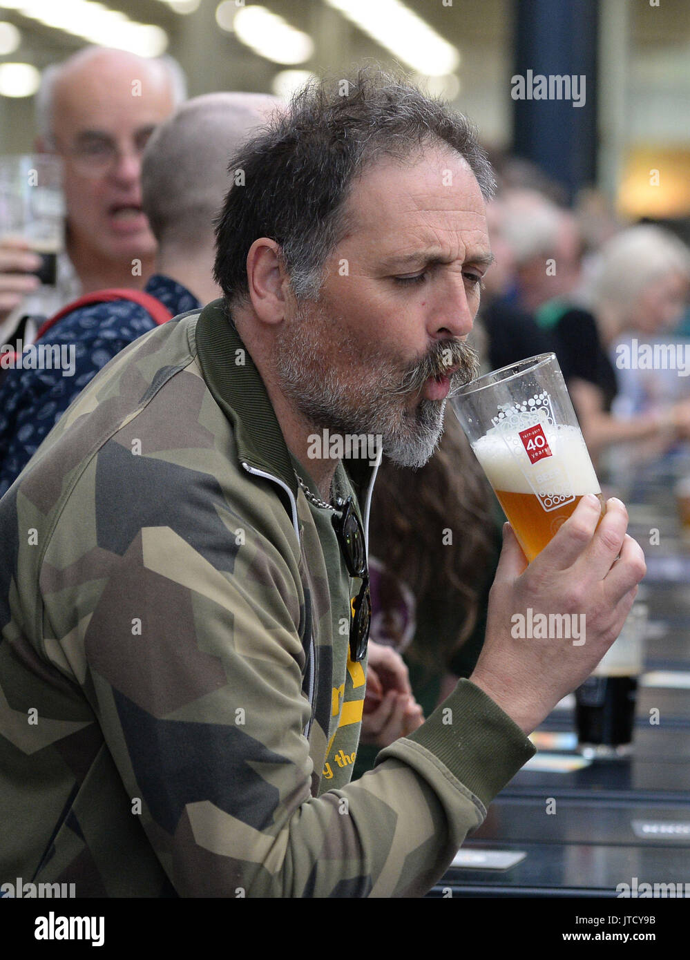 A visitor sizes up his drink at the Great British Beer Festival 2017 at Olympia in London. The festival, which is organised by the Campaign for Real Ale (CAMRA), is celebrating its 40th anniversary. Stock Photo