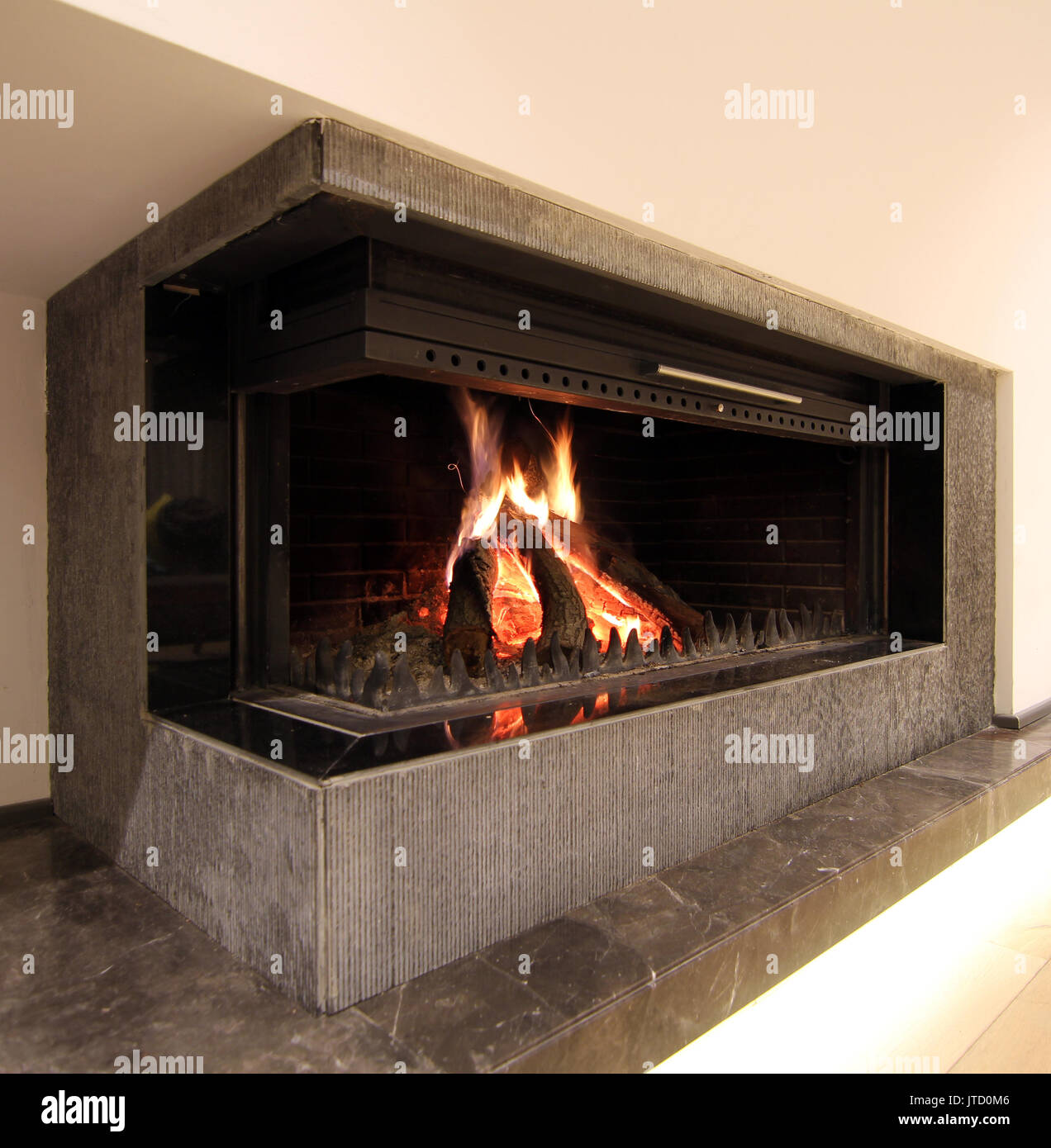 Burning fireplace. Fireplace as a piece of furniture Stock Photo Alamy