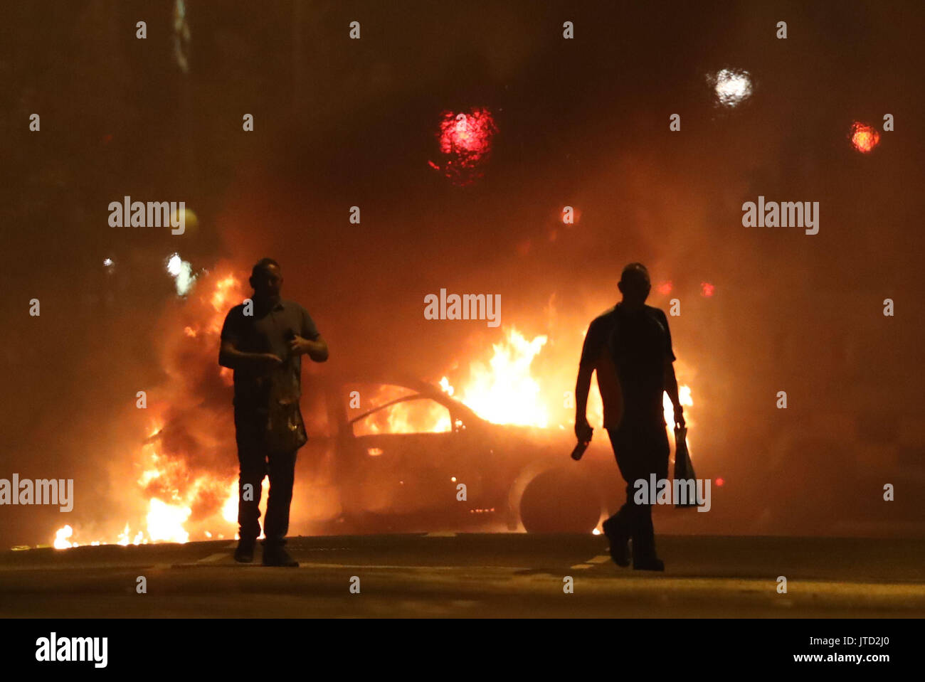 A car on fire in the North Queen Street area of Belfast, close to the site of a contentious bonfire. Stock Photo