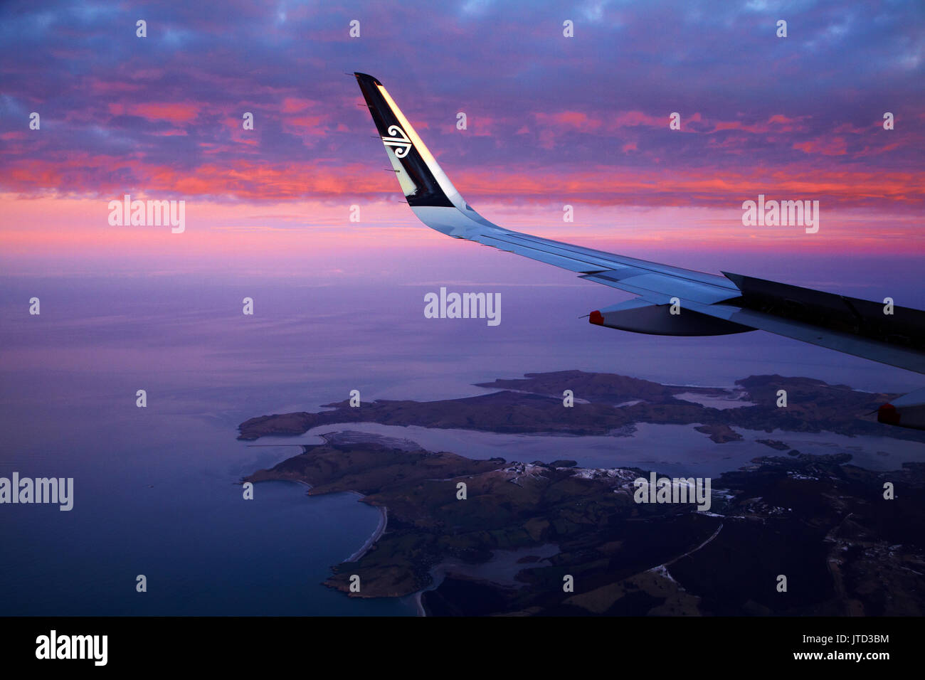 Otago Peninsula and Otago Harbour at sunset, Dunedin, South Island, New Zealand - aerial Stock Photo