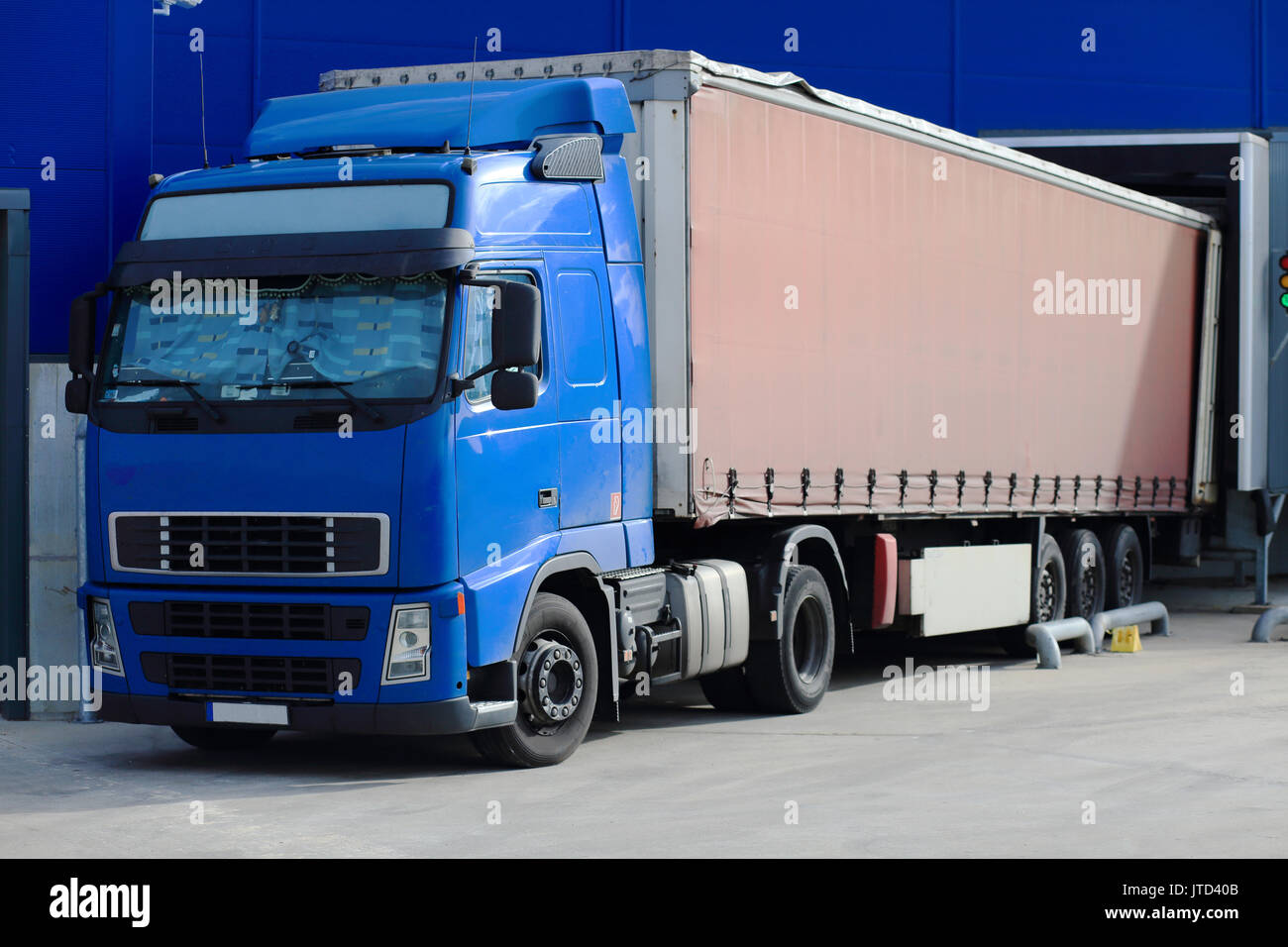 Truck at loading docks close-up. Cargo transportation theme. Stock Photo