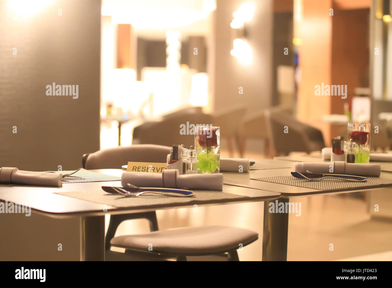 Reserved table in restaraunt close-up. Beautiful restaraunt interior in evening light. Stock Photo