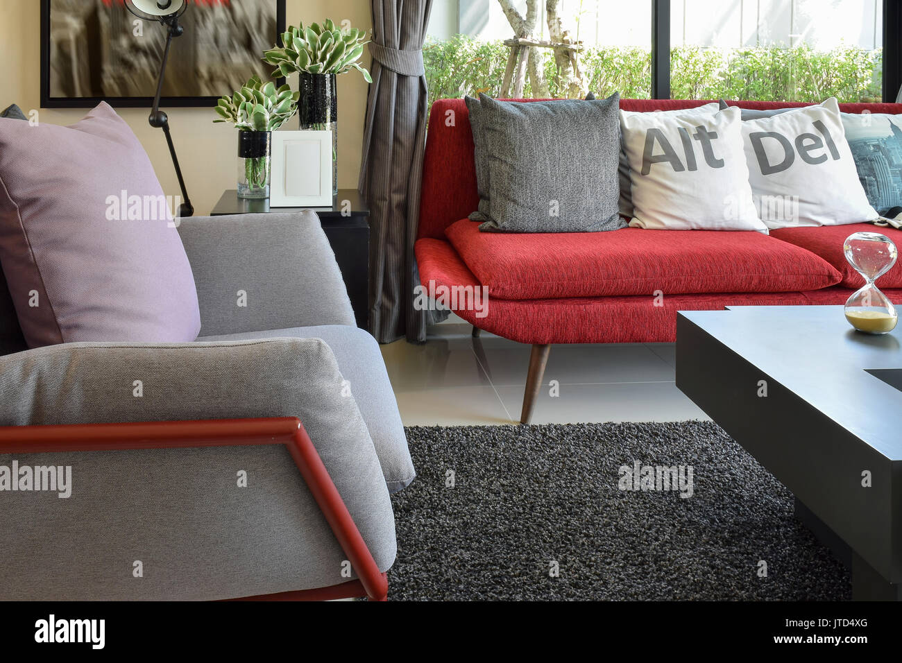 Modern Living Room Design With Pillows On The Red Sofa And