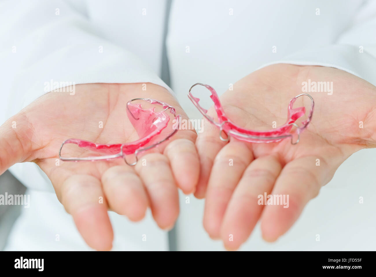 Dentist holding Retainer, Orthodontics Dental concept background Stock