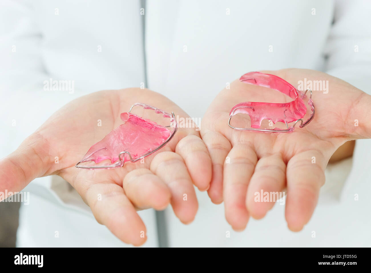 Dentist holding Retainer, Orthodontics Dental concept background Stock